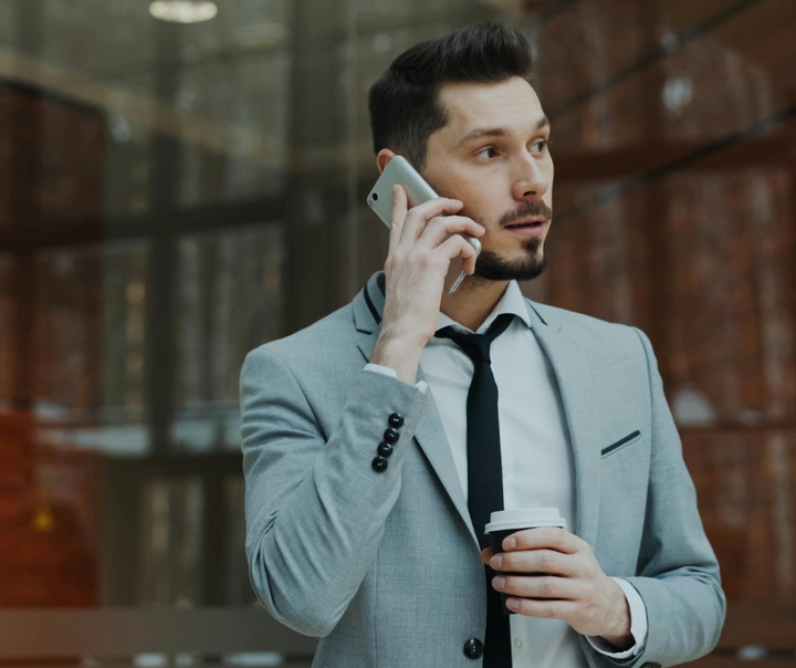 Business professional on phone discussing sales follow up with potential lead